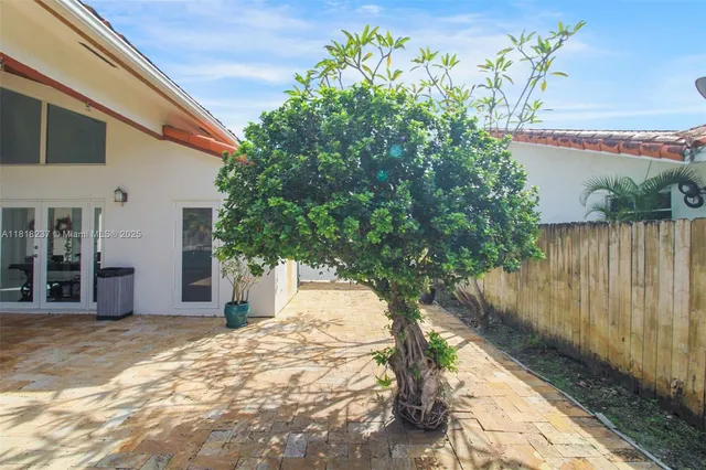 a yellow house with trees in front of it