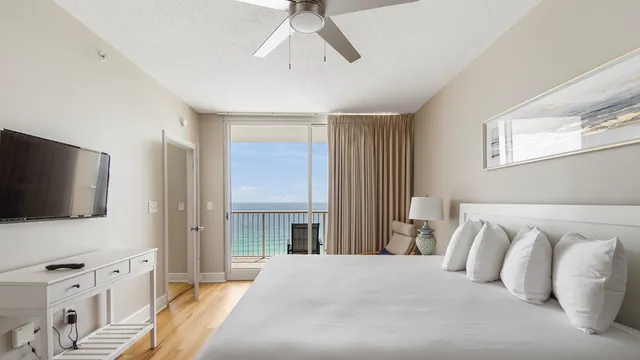 a bedroom with a large bed and a flat screen tv