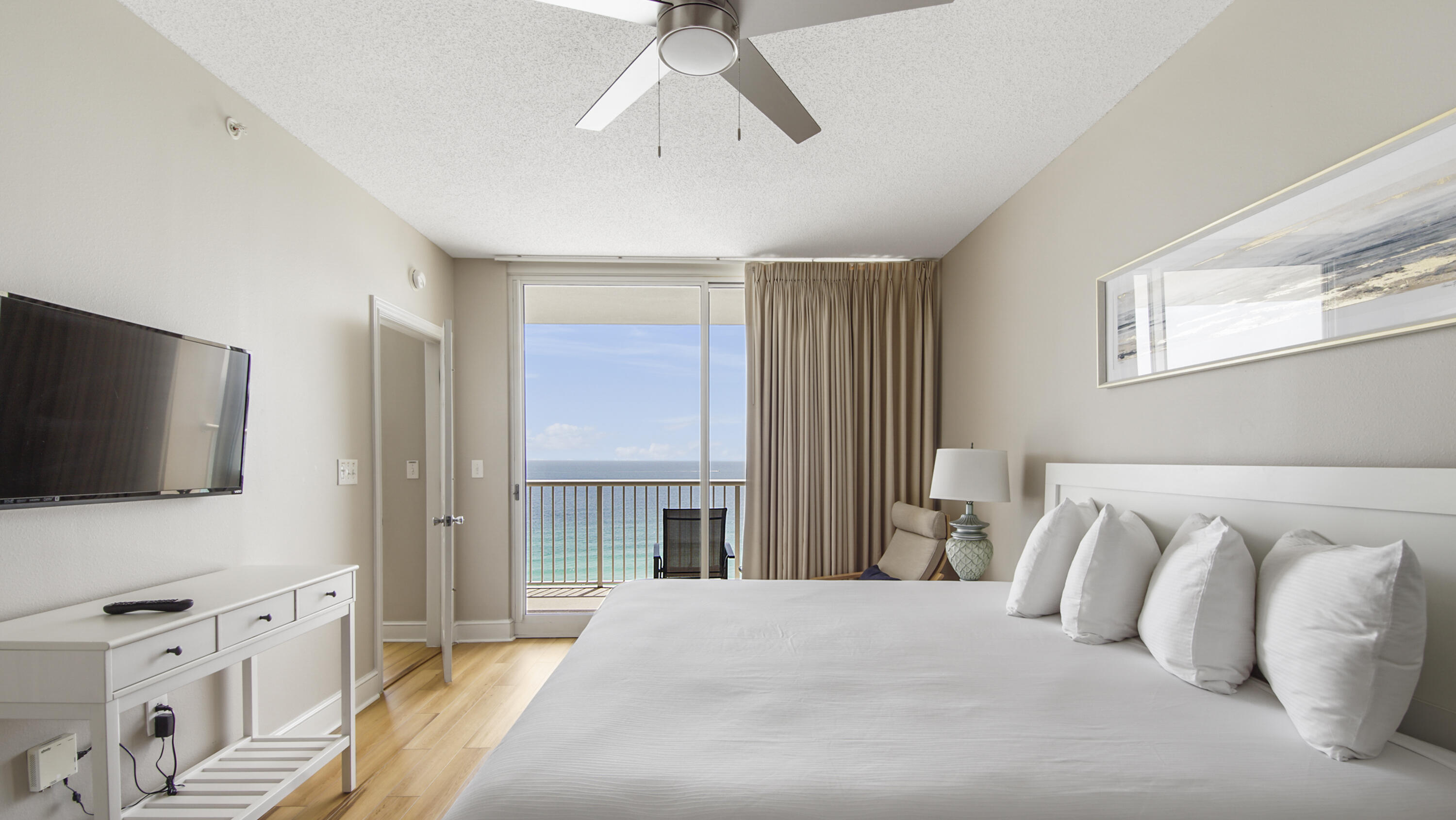 a bedroom with a large bed and a flat screen tv