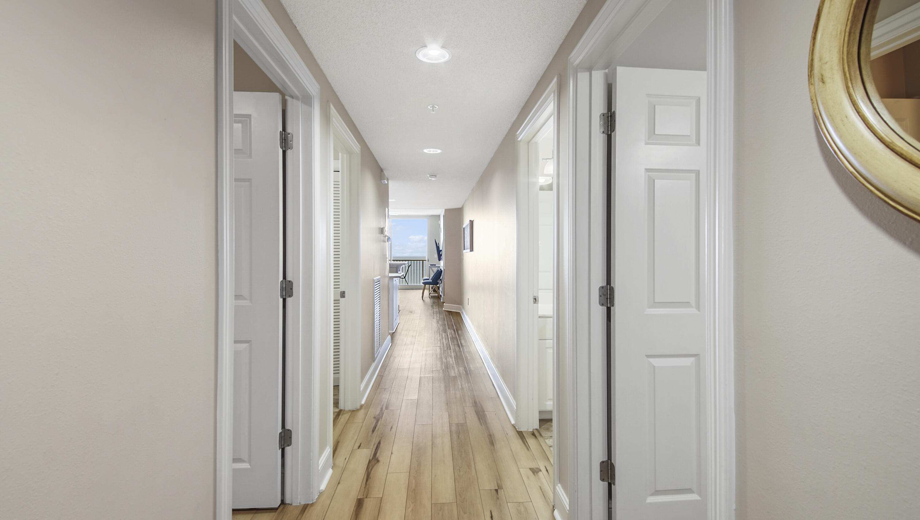 10811 Front Beach Road, Unit 1405 Panama City Beach, FL 32408 - Photo 13 of 76 a view of a hallway with wooden floor and staircase