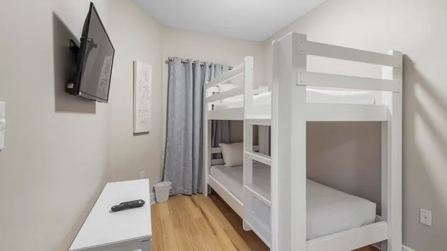 a bedroom with a bed and hallway