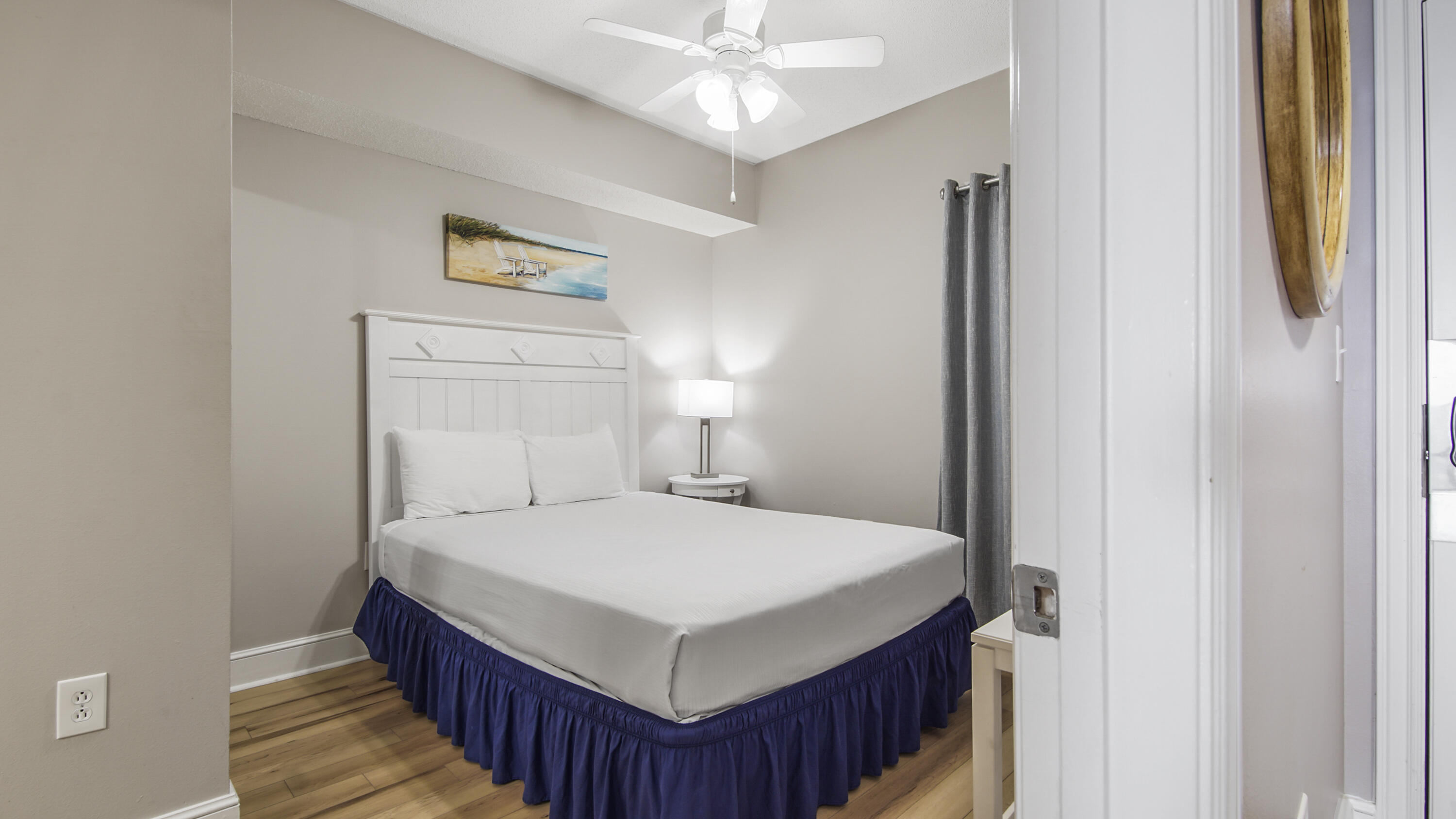 10811 Front Beach Road, Unit 1405 Panama City Beach, FL 32408 - Photo 17 of 76 a bedroom with a bed and a chandelier