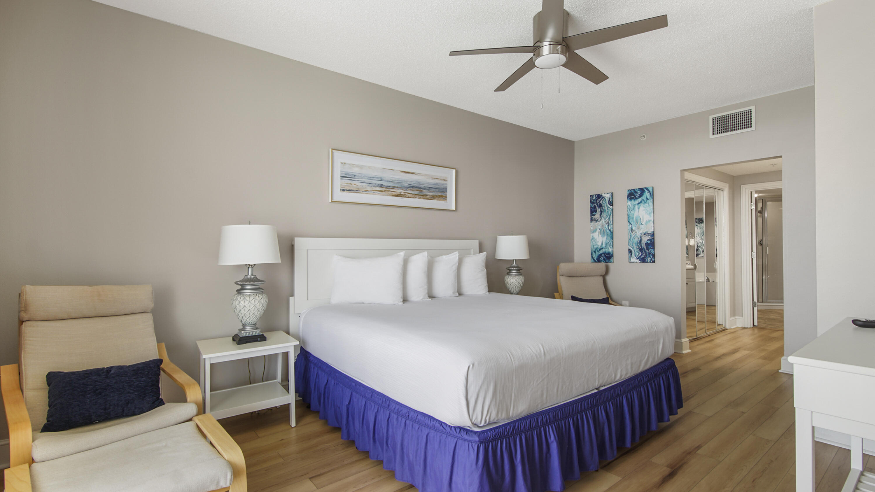 10811 Front Beach Road, Unit 1405 Panama City Beach, FL 32408 - Photo 27 of 76 a bedroom with a large bed and a chandelier