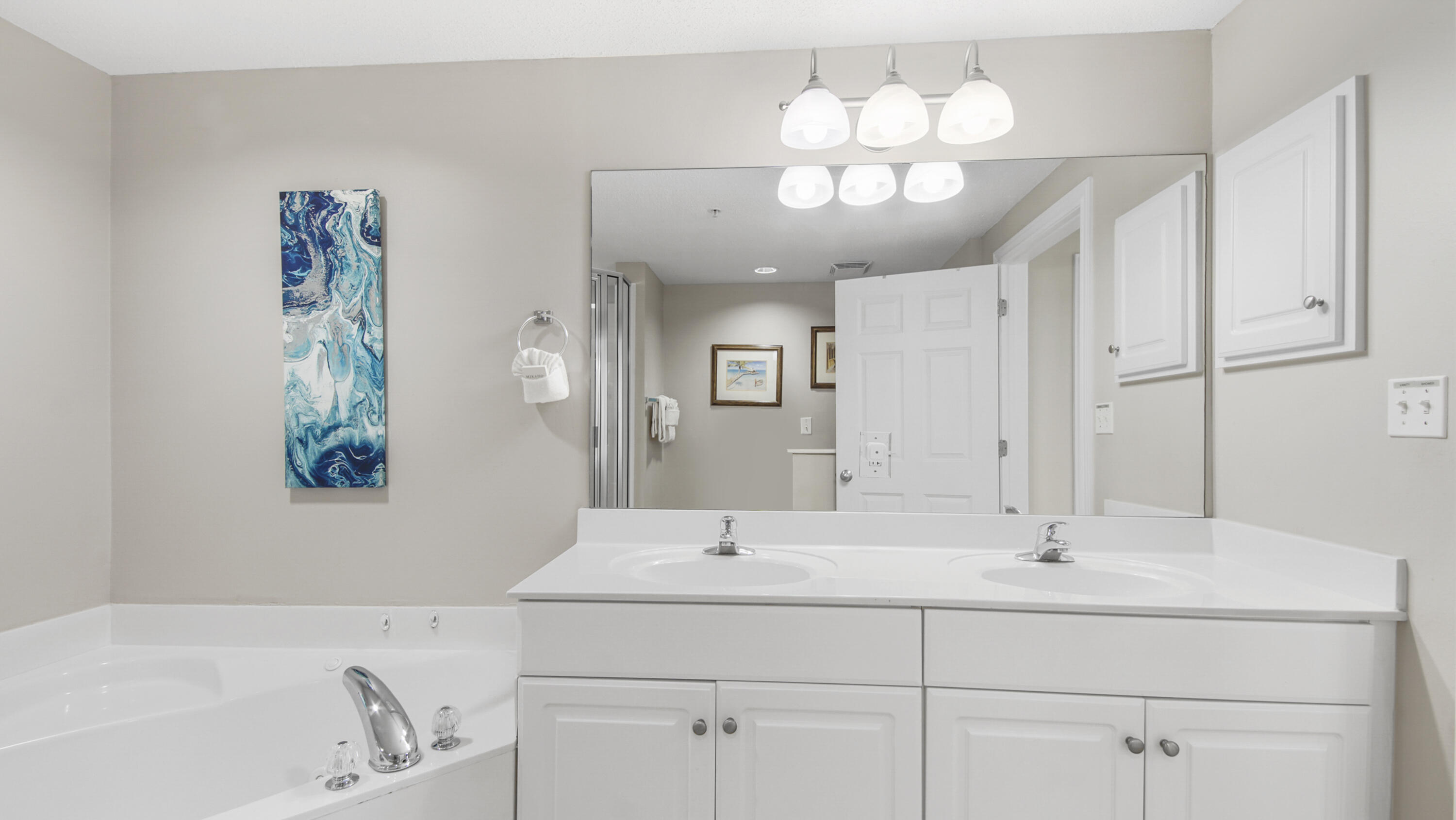 10811 Front Beach Road, Unit 1405 Panama City Beach, FL 32408 - Photo 32 of 76 a bathroom with a sink and a mirror