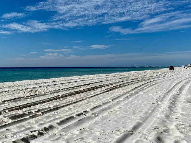 a living room with furniture a large window and a flat screen tv