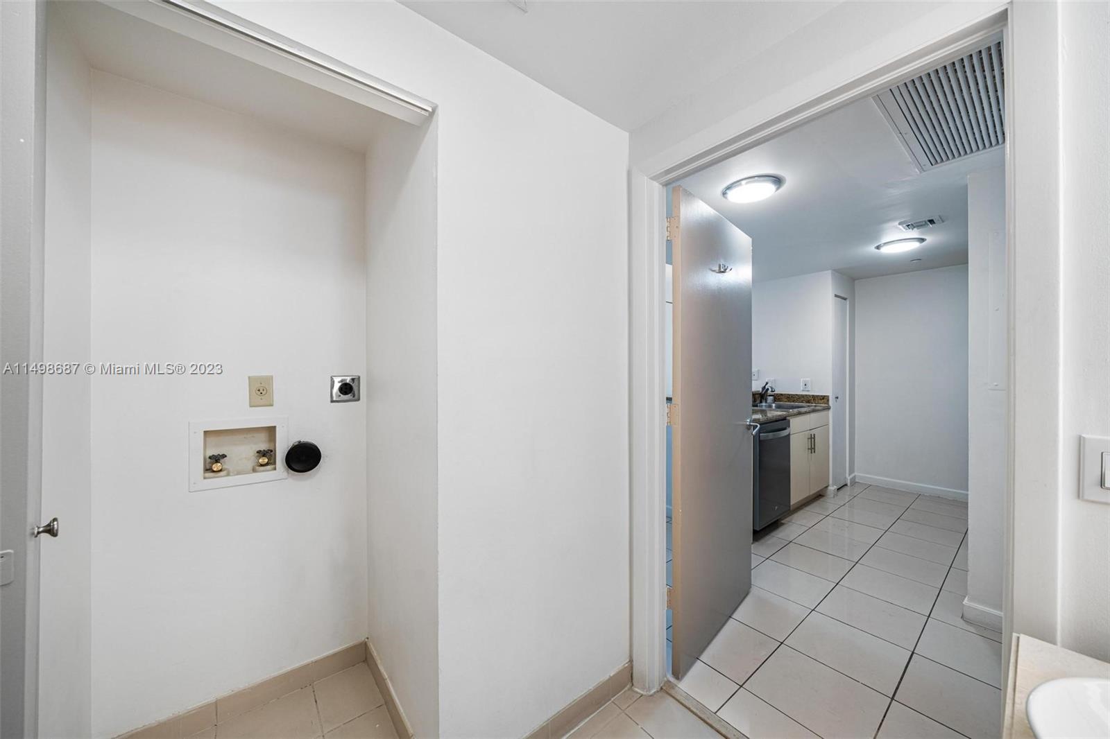 2889 McFarlane Road, Unit 1414 Miami, FL 33133 - Photo 12 of 15 a view of a hallway with a kitchen space