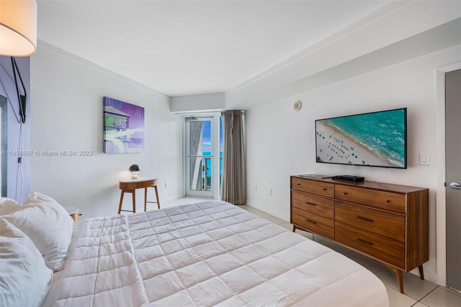 2889 McFarlane Road, Unit 1414 Miami, FL 33133 - Photo 8 of 15 a bedroom with a bed and a flat screen tv