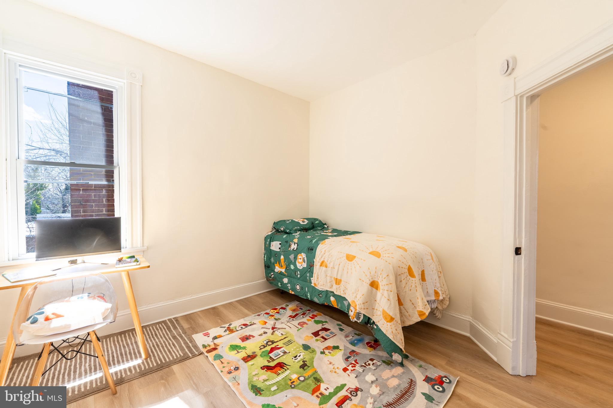 511 East 35th Street Baltimore, MD 21218 - Photo 11 of 19 a bedroom with a bed and a window