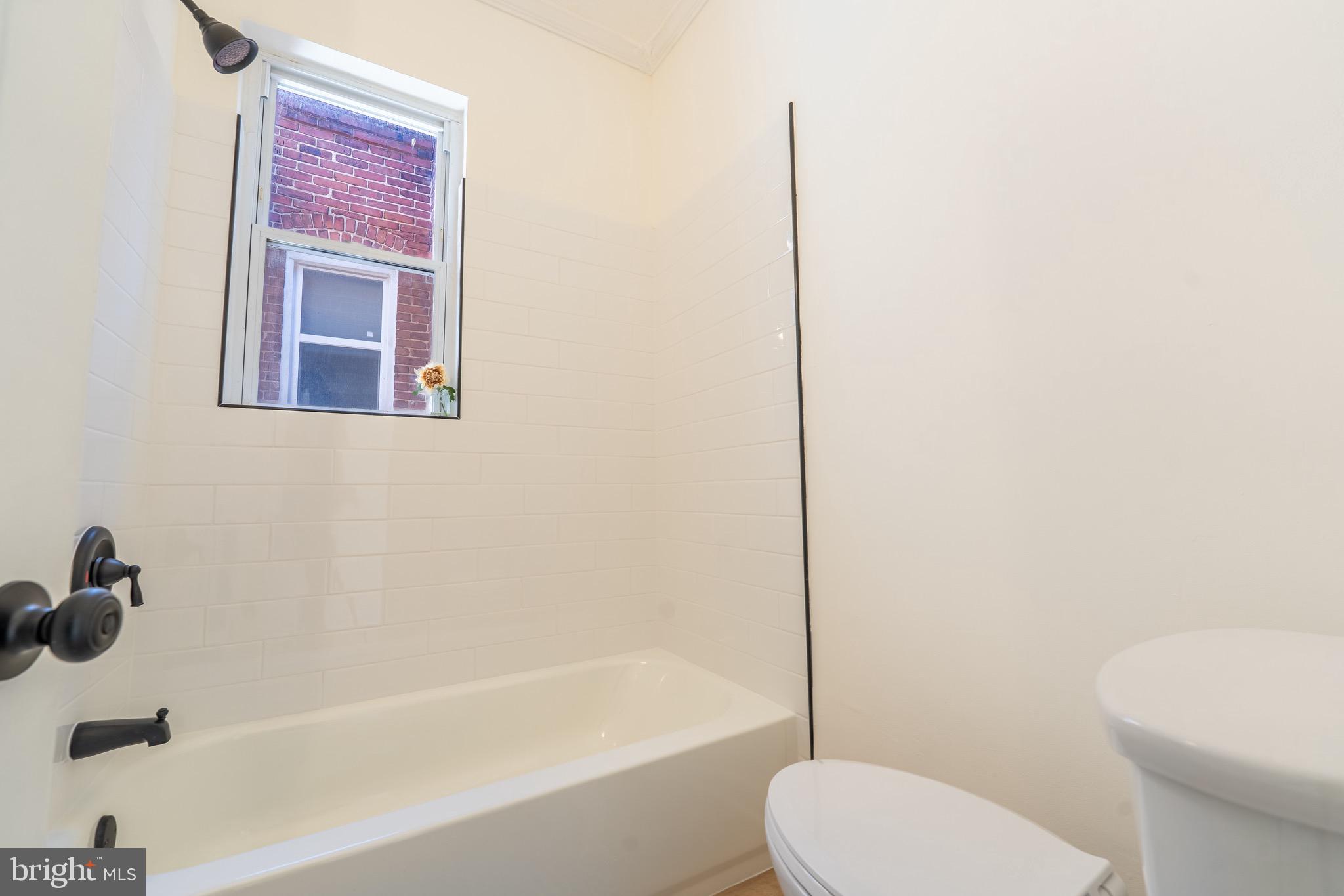511 East 35th Street Baltimore, MD 21218 - Photo 14 of 19 a bathroom with a toilet and a bathtub