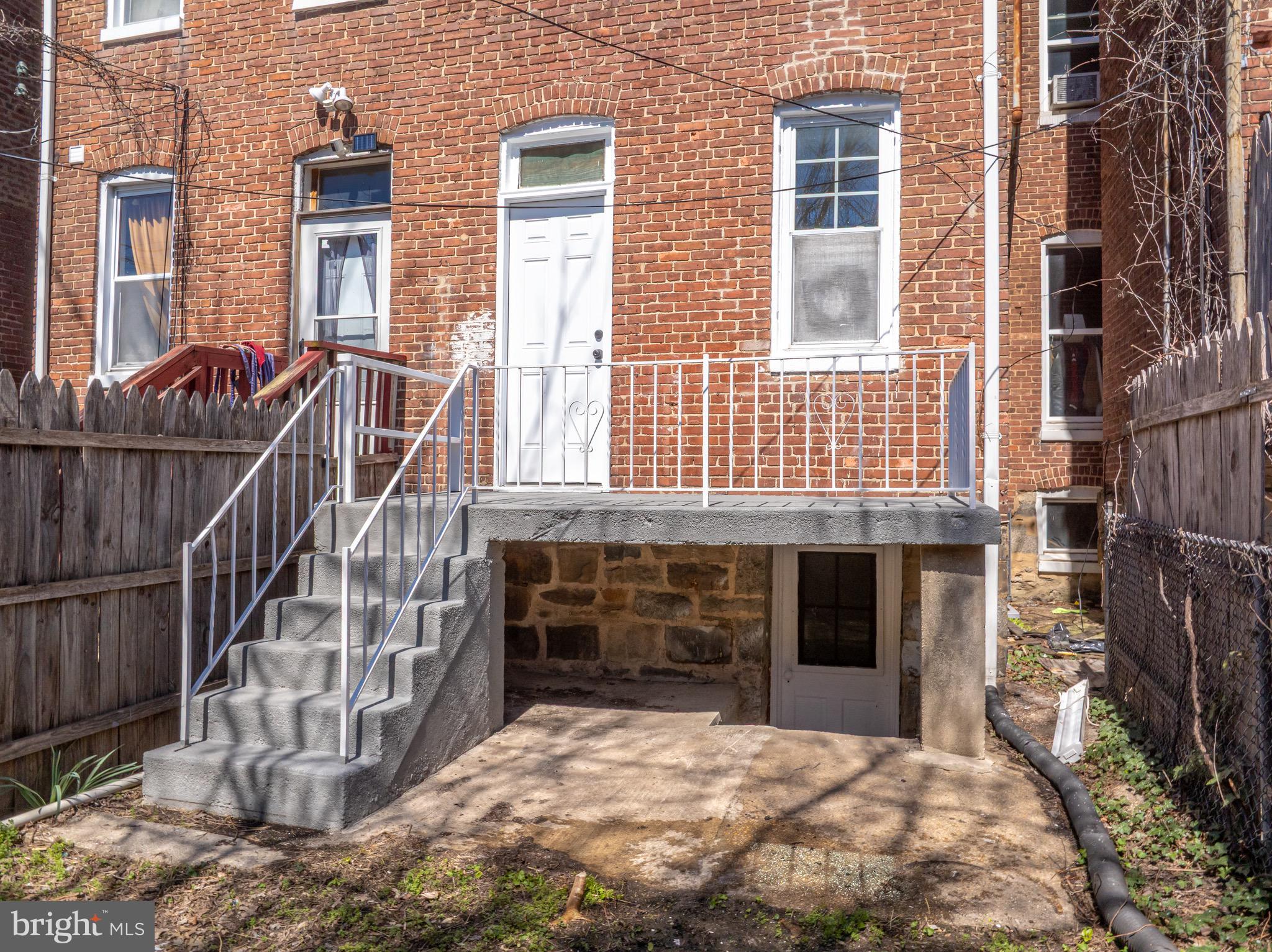 511 East 35th Street Baltimore, MD 21218 - Photo 18 of 19 a view of a house with a yard and balcony