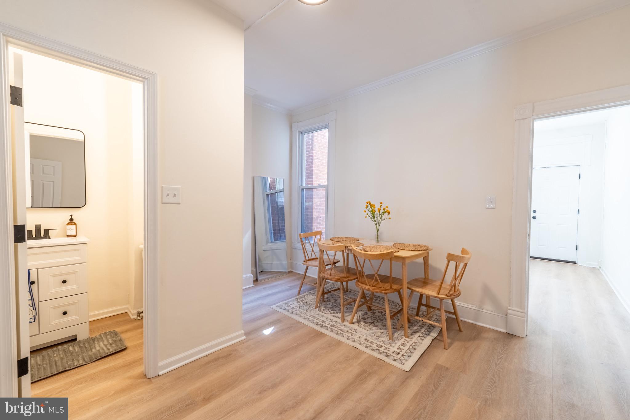511 East 35th Street Baltimore, MD 21218 - Photo 7 of 19 a dining room with furniture and wooden floor