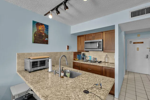 a kitchen with a stove a microwave and refrigerator