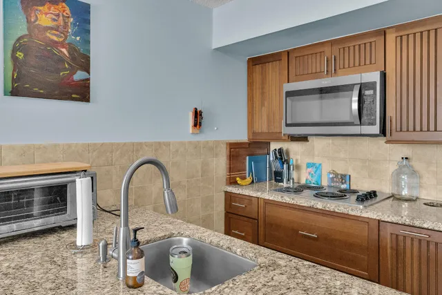 a kitchen with a stove a sink and a microwave