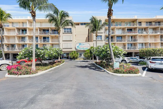 a view of a street with a cars parked in front of it
