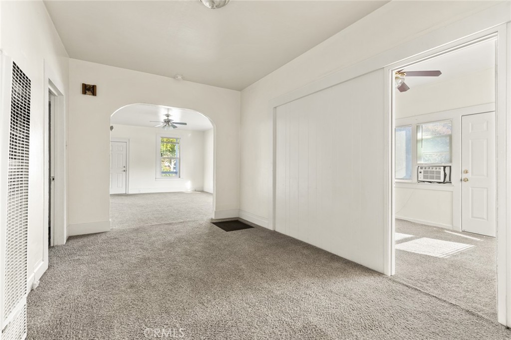 340 Oak Street Chico, CA 95928 - Photo 6 of 14 an empty room that has a large window and wooden floor