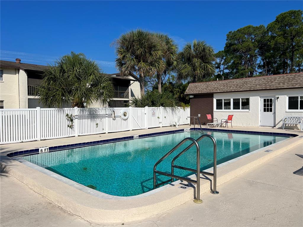 5521 Bay Boulevard, Unit 105 Port Richey, FL 34668 - Photo 13 of 15 a swimming pool with outdoor seating and yard