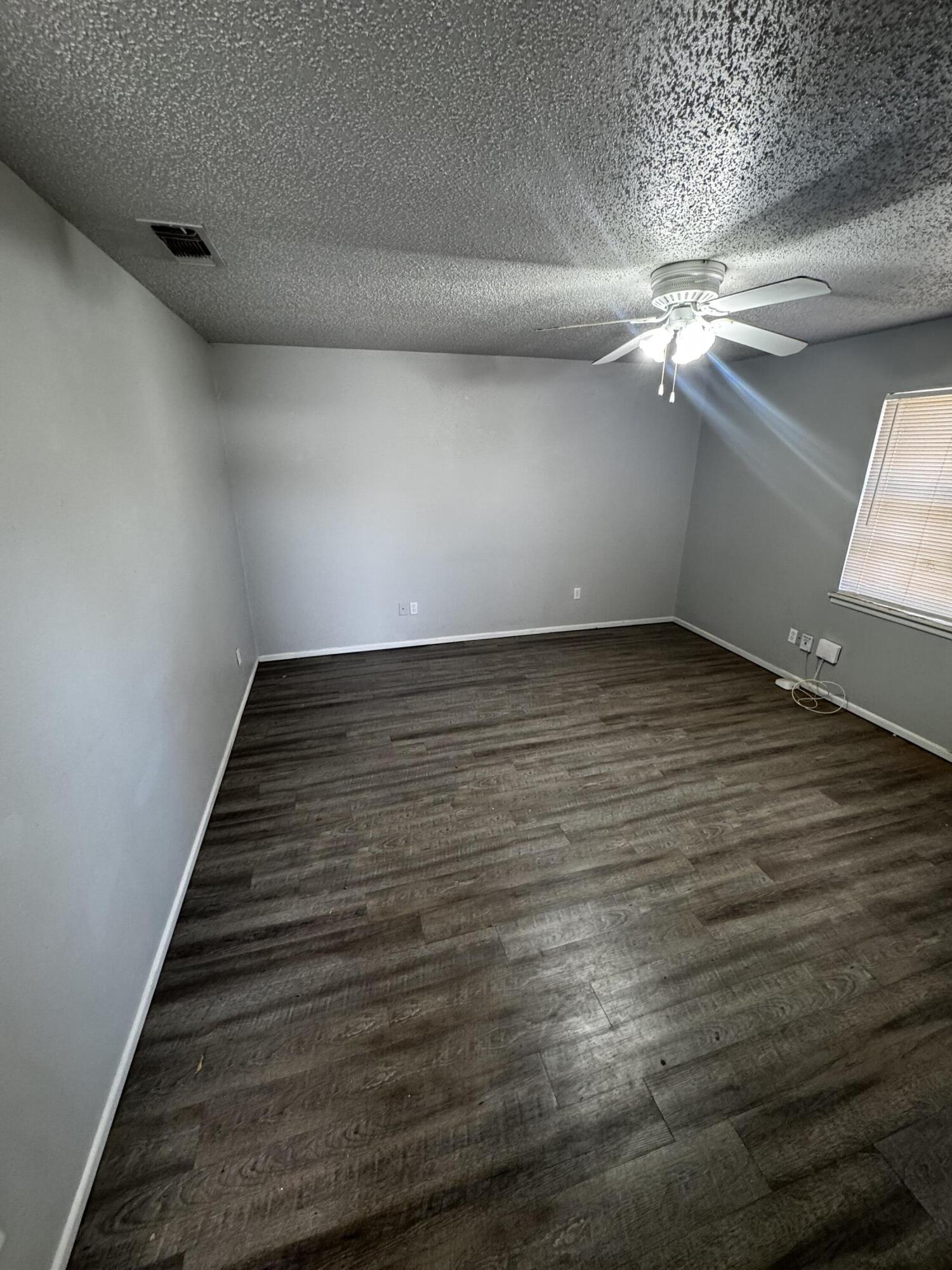 6113 37th Street, Unit B Lubbock, TX 79407 - Photo 4 of 10 a view of a room with wooden floor