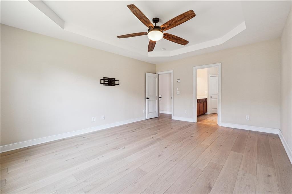 5145 Rialto Way Cumming, GA 30040 - Photo 11 of 25 an empty room with wooden floor and a ceiling fan