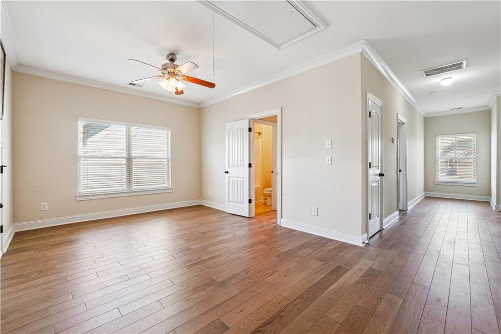 5145 Rialto Way Cumming, GA 30040 - Photo 15 of 25 an empty room with wooden floor chandelier and windows