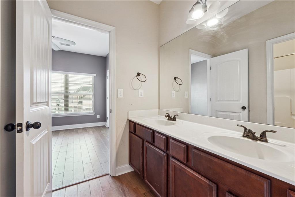 5145 Rialto Way Cumming, GA 30040 - Photo 16 of 25 a bathroom with a sink double vanity granite tub and shower