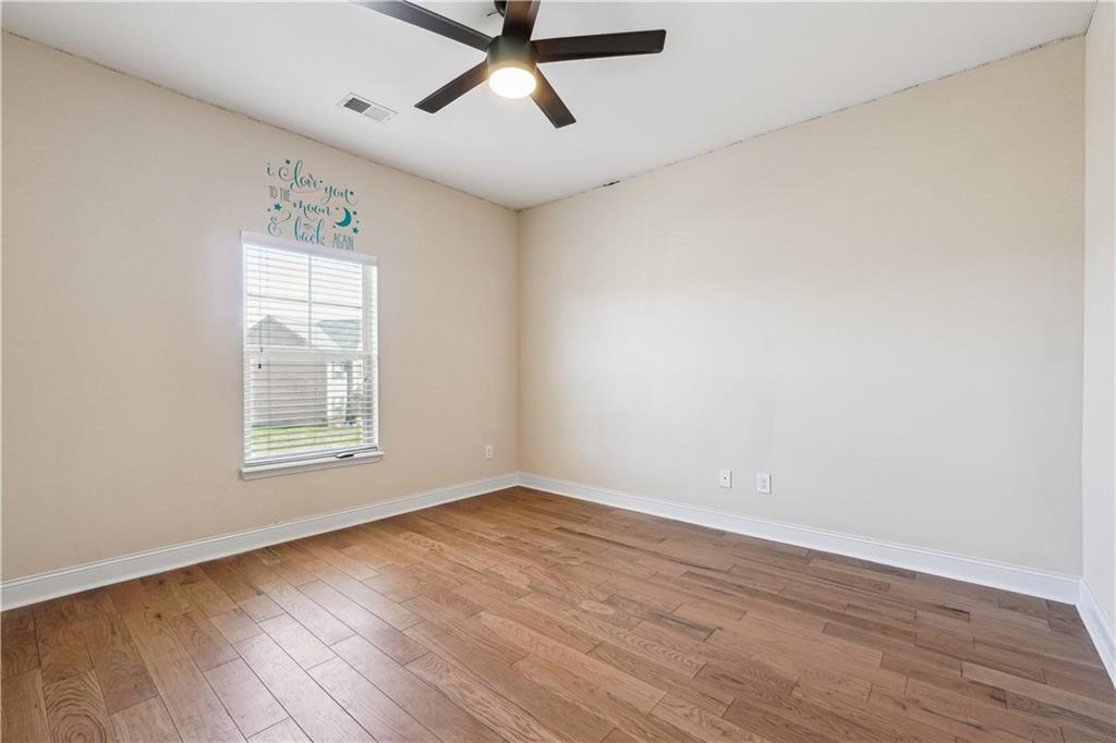 5145 Rialto Way Cumming, GA 30040 - Photo 18 of 25 an empty room with wooden floor and windows
