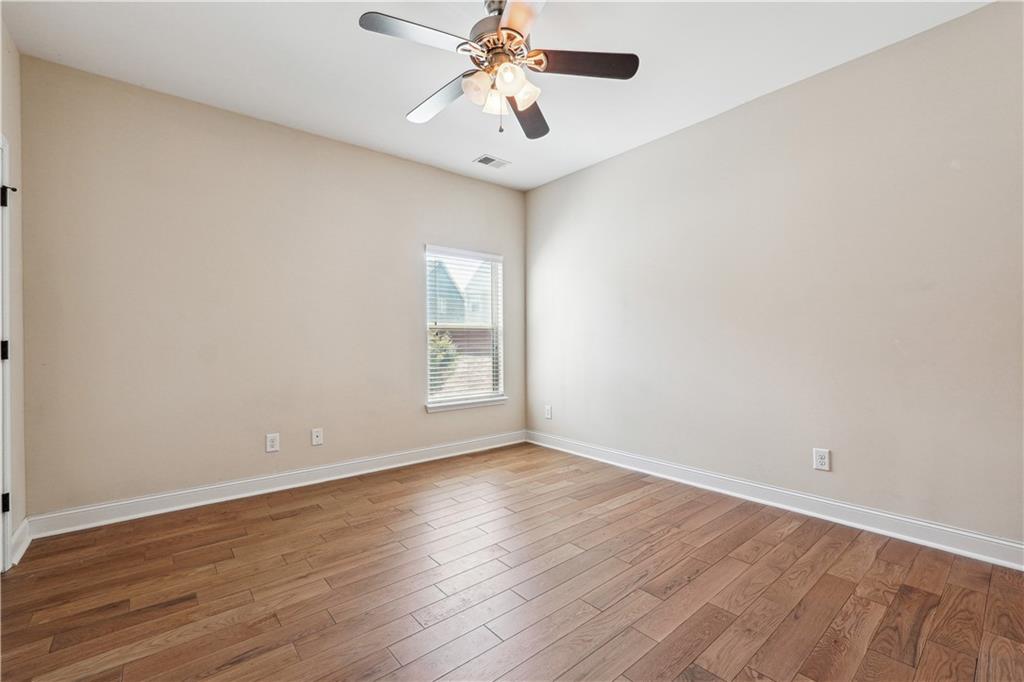 5145 Rialto Way Cumming, GA 30040 - Photo 19 of 25 wooden floor in an empty room with a window