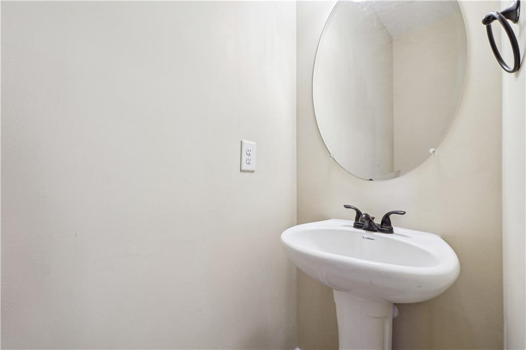 5145 Rialto Way Cumming, GA 30040 - Photo 22 of 25 a bathroom with a sink and a mirror