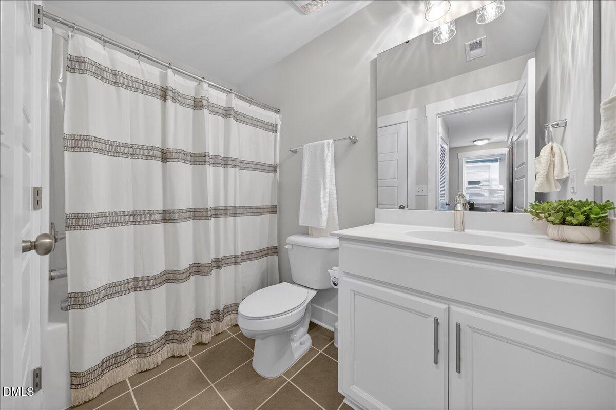 251 Daniel Ridge Road Wendell, NC 27591 - Photo 33 of 73 a bathroom with a sink a toilet and shower
