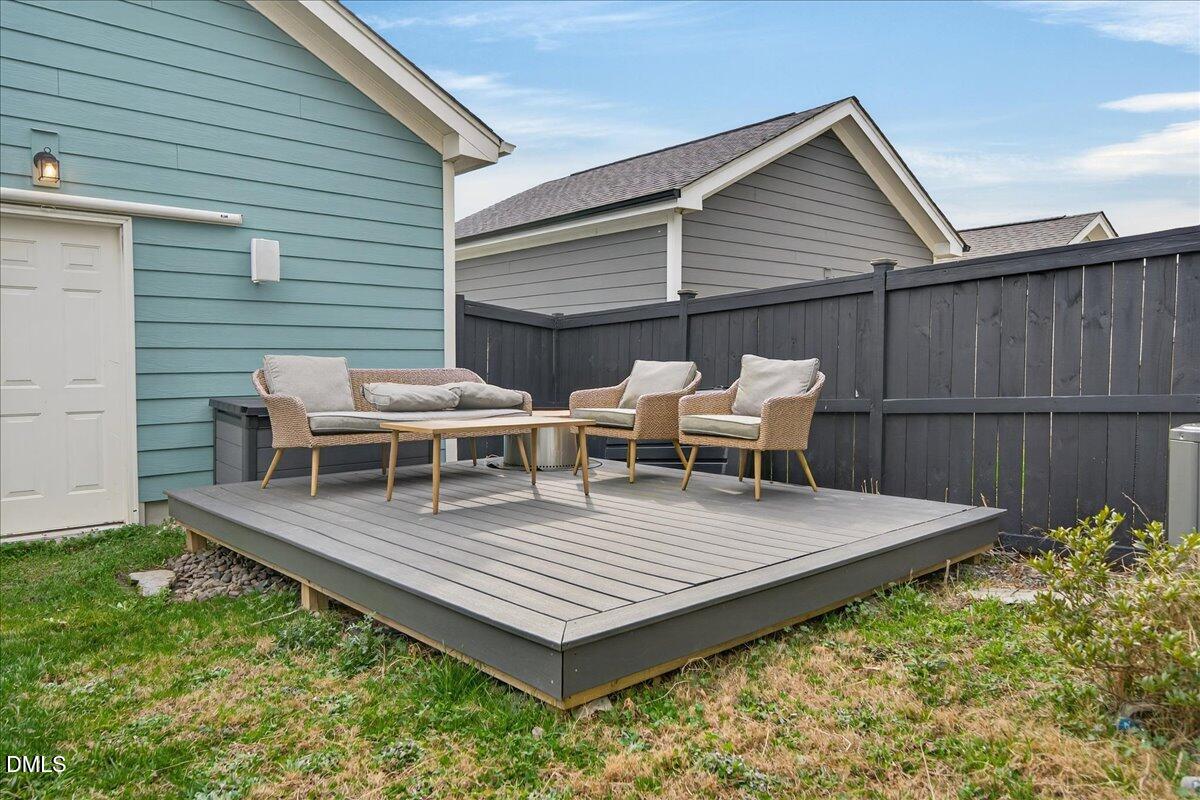 251 Daniel Ridge Road Wendell, NC 27591 - Photo 37 of 73 a view of a patio with table and chairs with wooden floor and fence