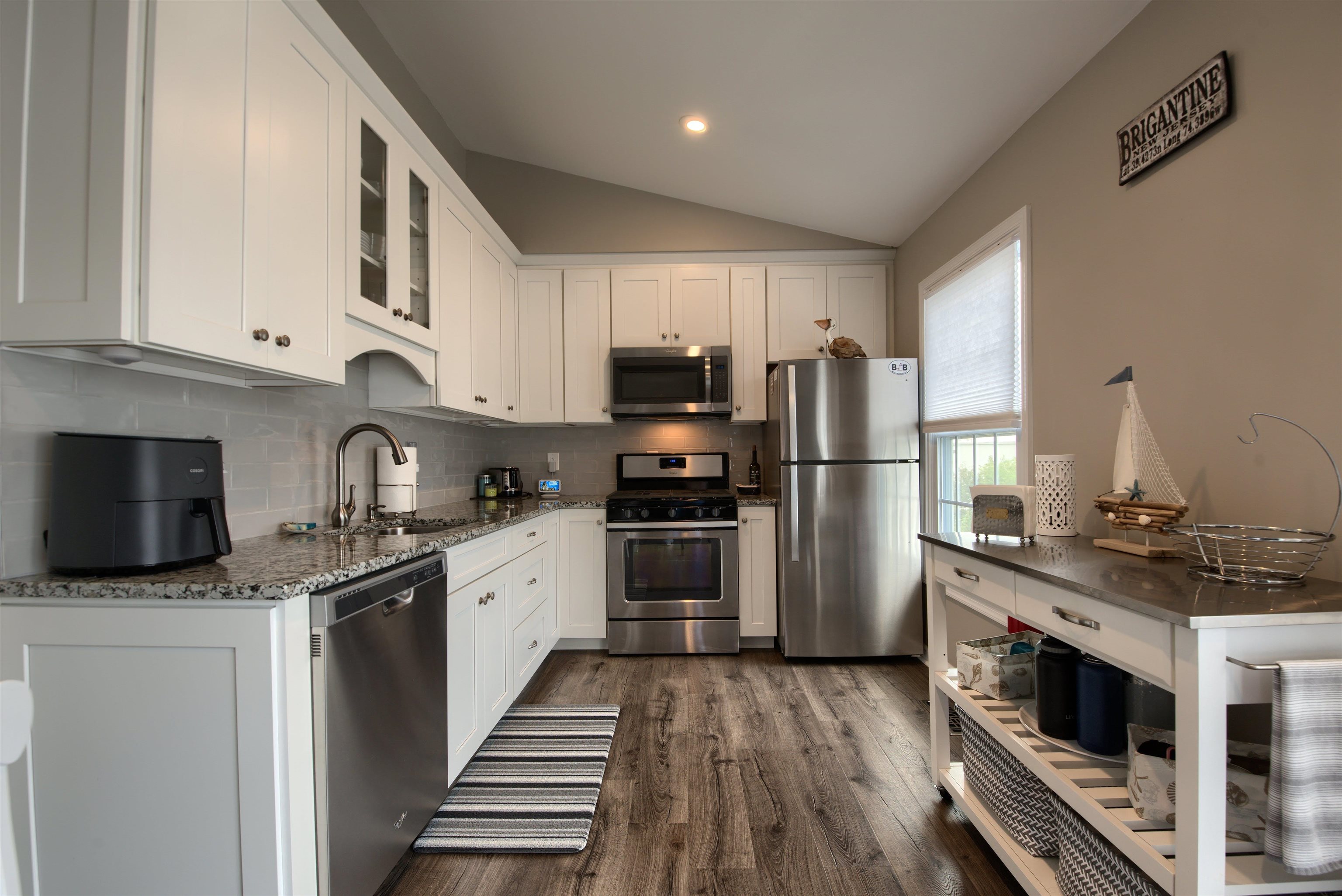167 South 40th, Unit 2 Brigantine, NJ 08203 - Photo 11 of 28 a kitchen with stainless steel appliances kitchen island granite countertop a stove sink and refrigerator