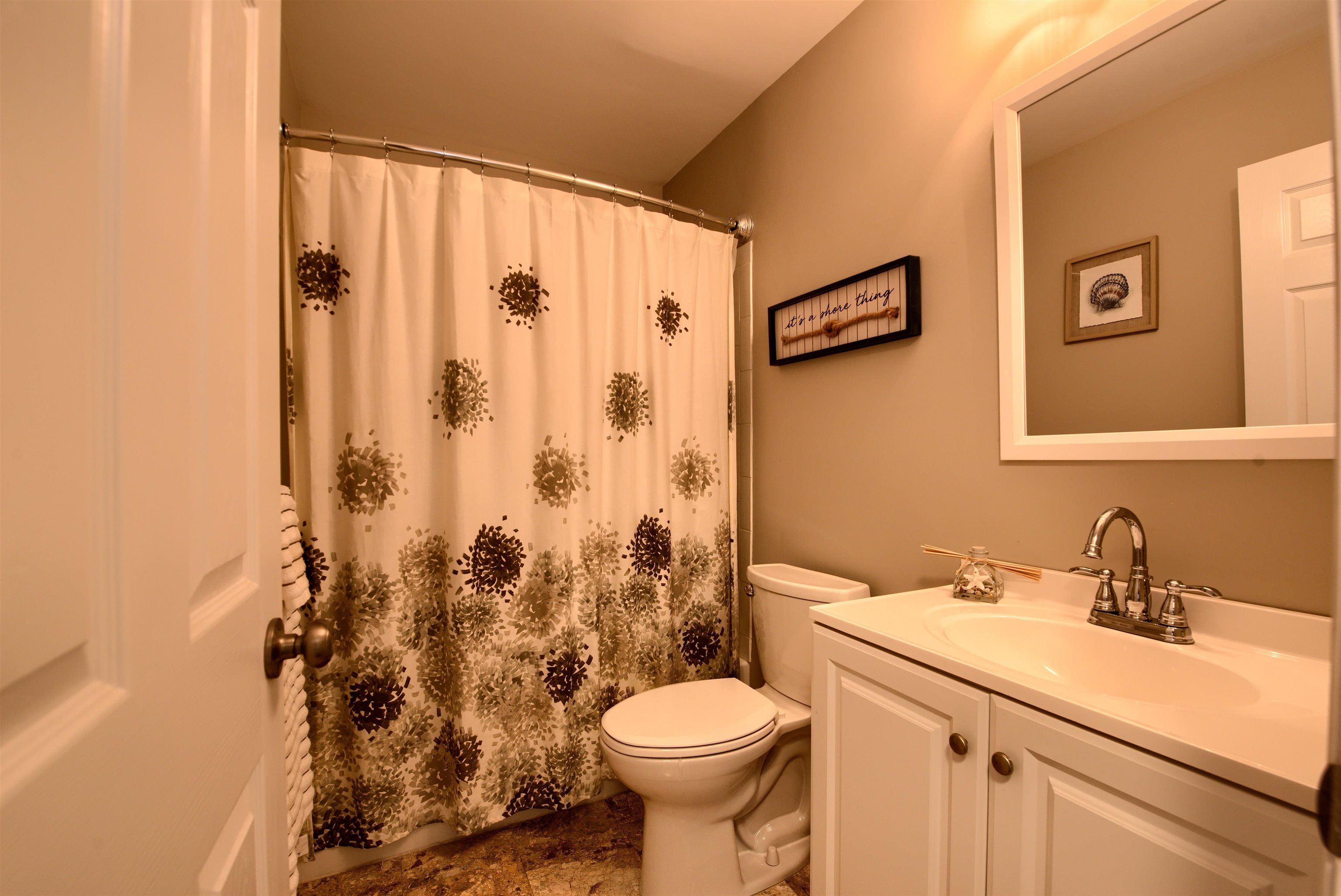 167 South 40th, Unit 2 Brigantine, NJ 08203 - Photo 20 of 28 a bathroom with a sink a toilet and a mirror