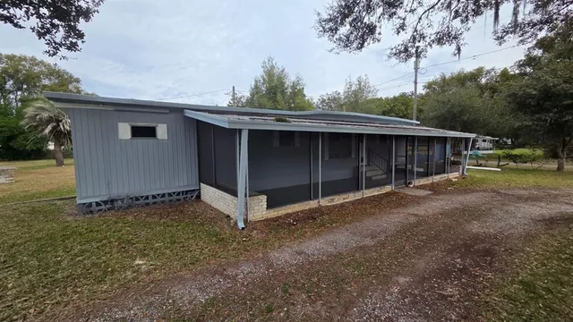 a view of backyard with small cabin and wooden fence