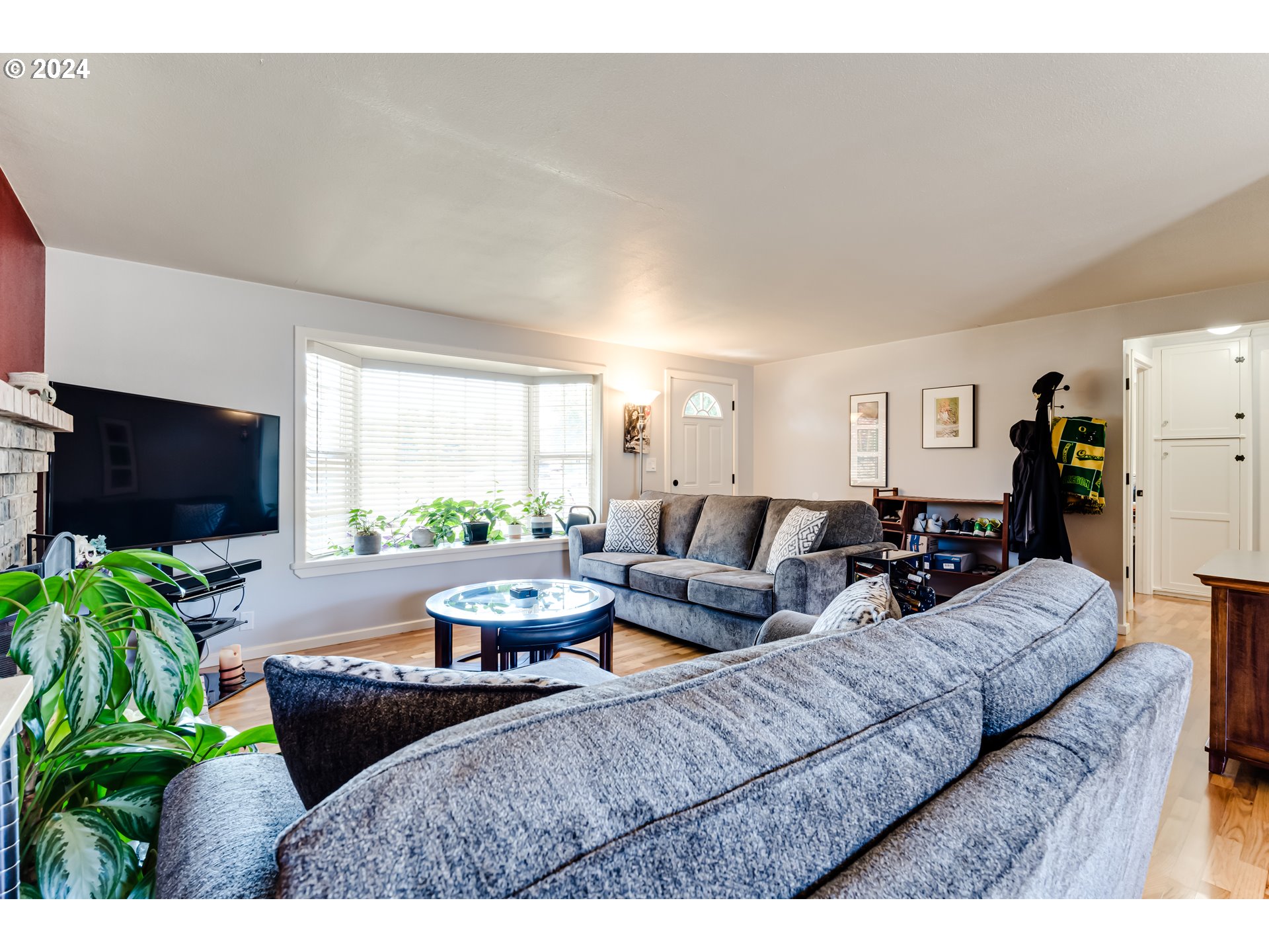 3715 Harlow Road Eugene, OR 97401 - Photo 12 of 39 a living room with furniture a flat screen tv and a large window