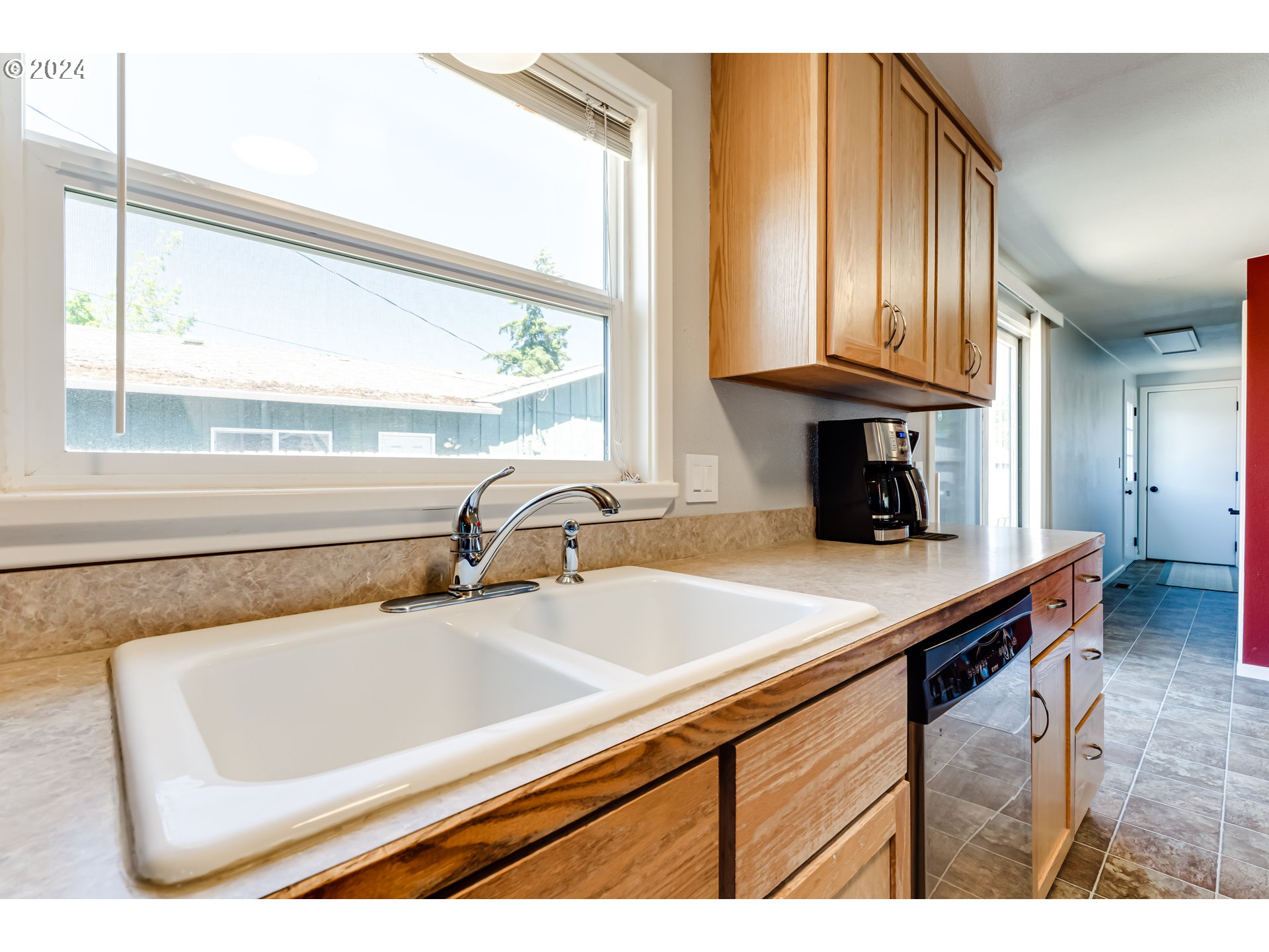 3715 Harlow Road Eugene, OR 97401 - Photo 15 of 39 a kitchen with a sink cabinets and a large window