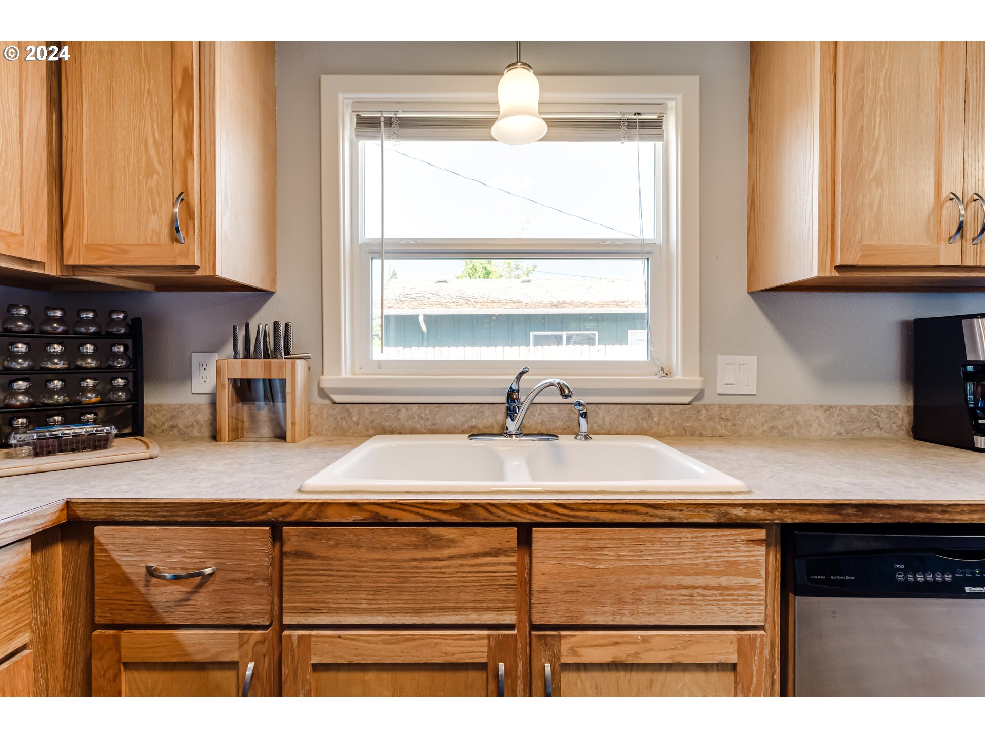 3715 Harlow Road Eugene, OR 97401 - Photo 16 of 39 a kitchen with granite countertop a sink window and cabinets
