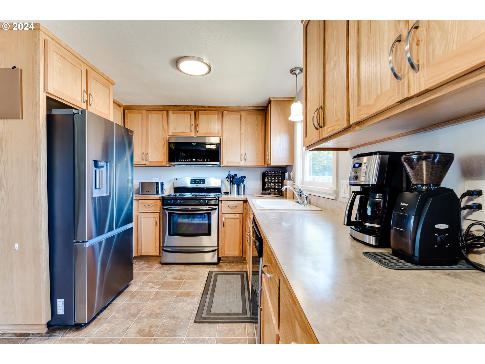 3715 Harlow Road Eugene, OR 97401 - Photo 18 of 39 a kitchen with stainless steel appliances granite countertop a refrigerator and a stove top oven