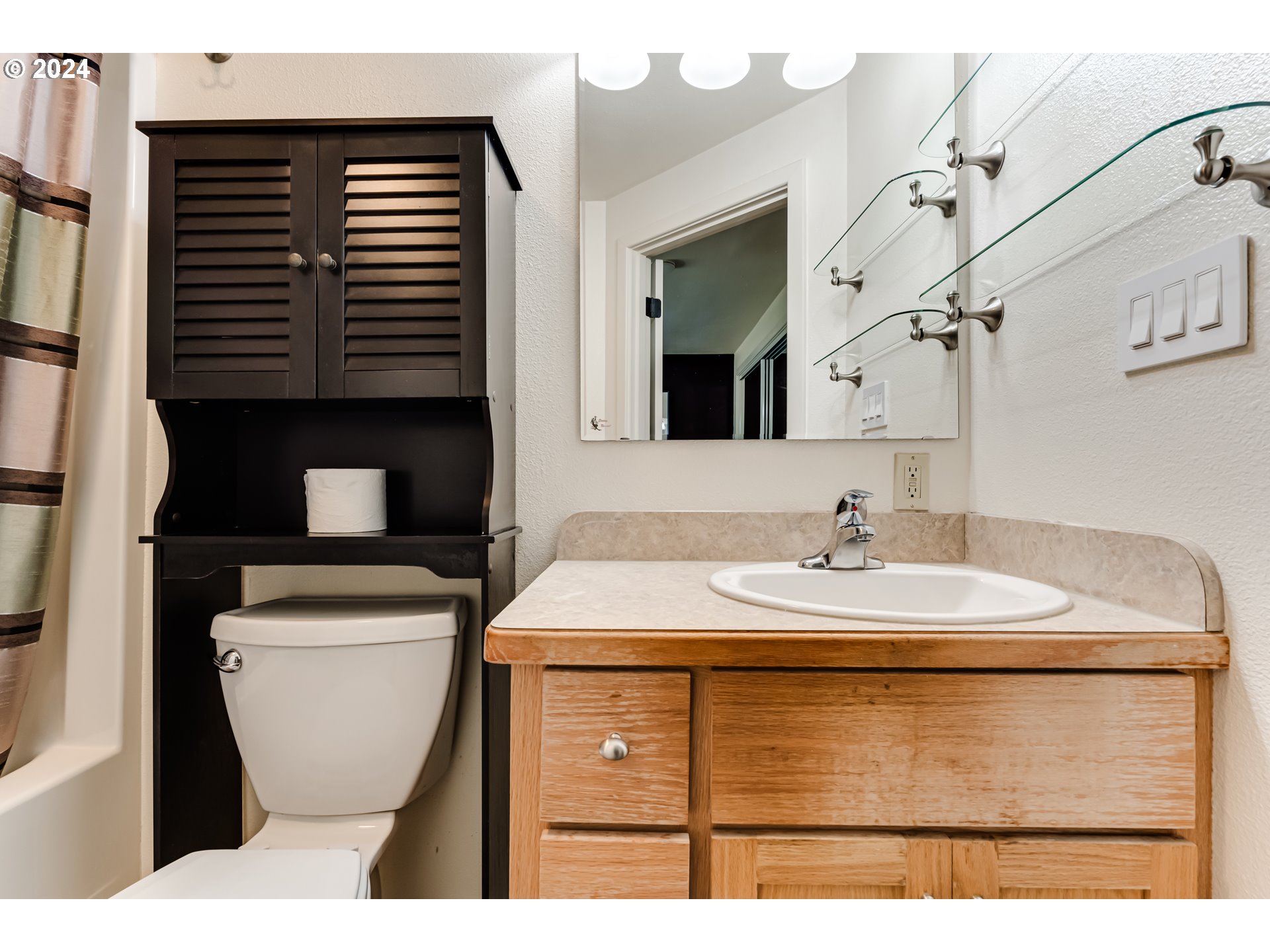 3715 Harlow Road Eugene, OR 97401 - Photo 25 of 39 a bathroom with a sink a toilet and a mirror