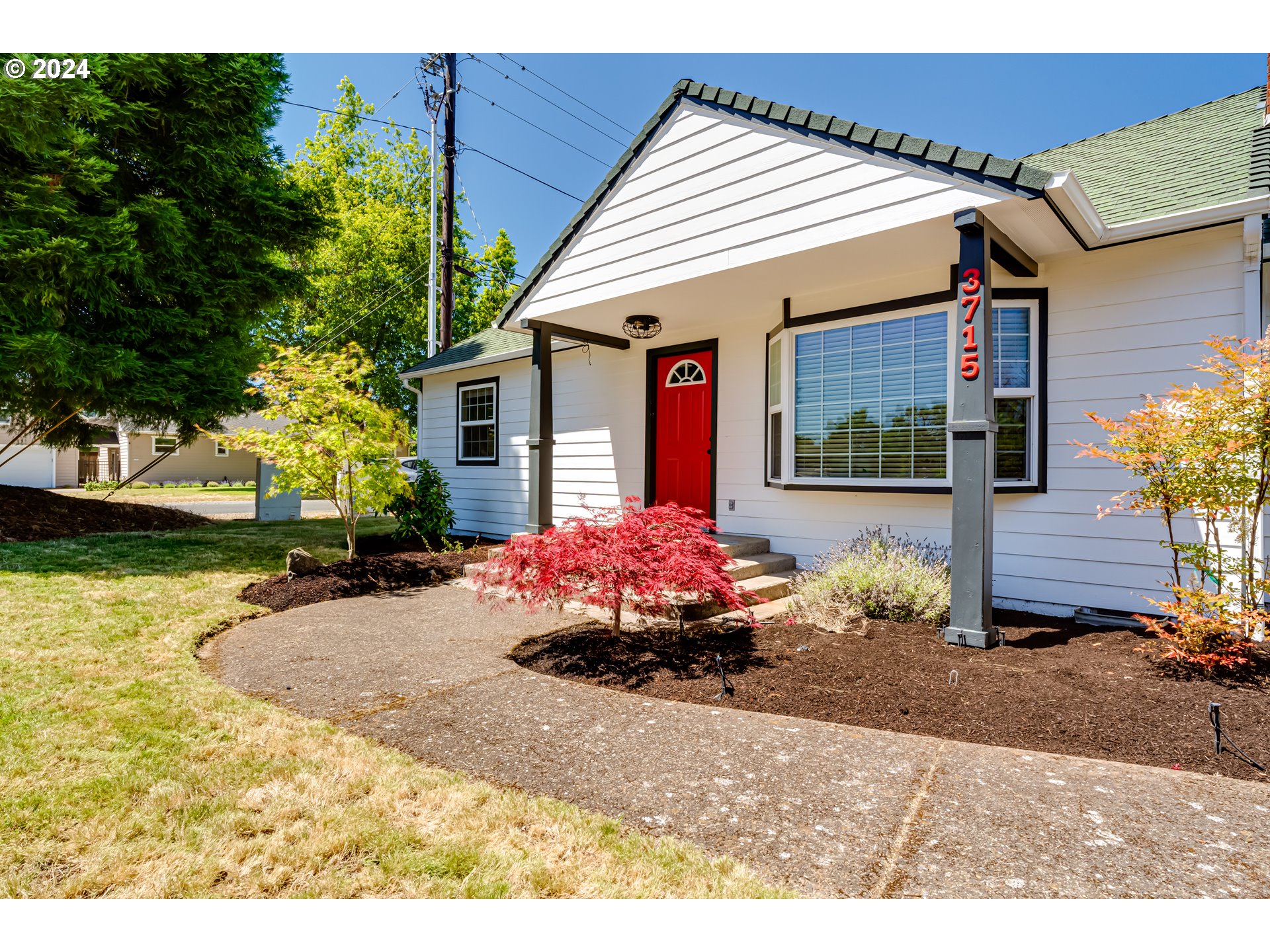 3715 Harlow Road Eugene, OR 97401 - Photo 4 of 39 a front view of a house with a yard and a garage