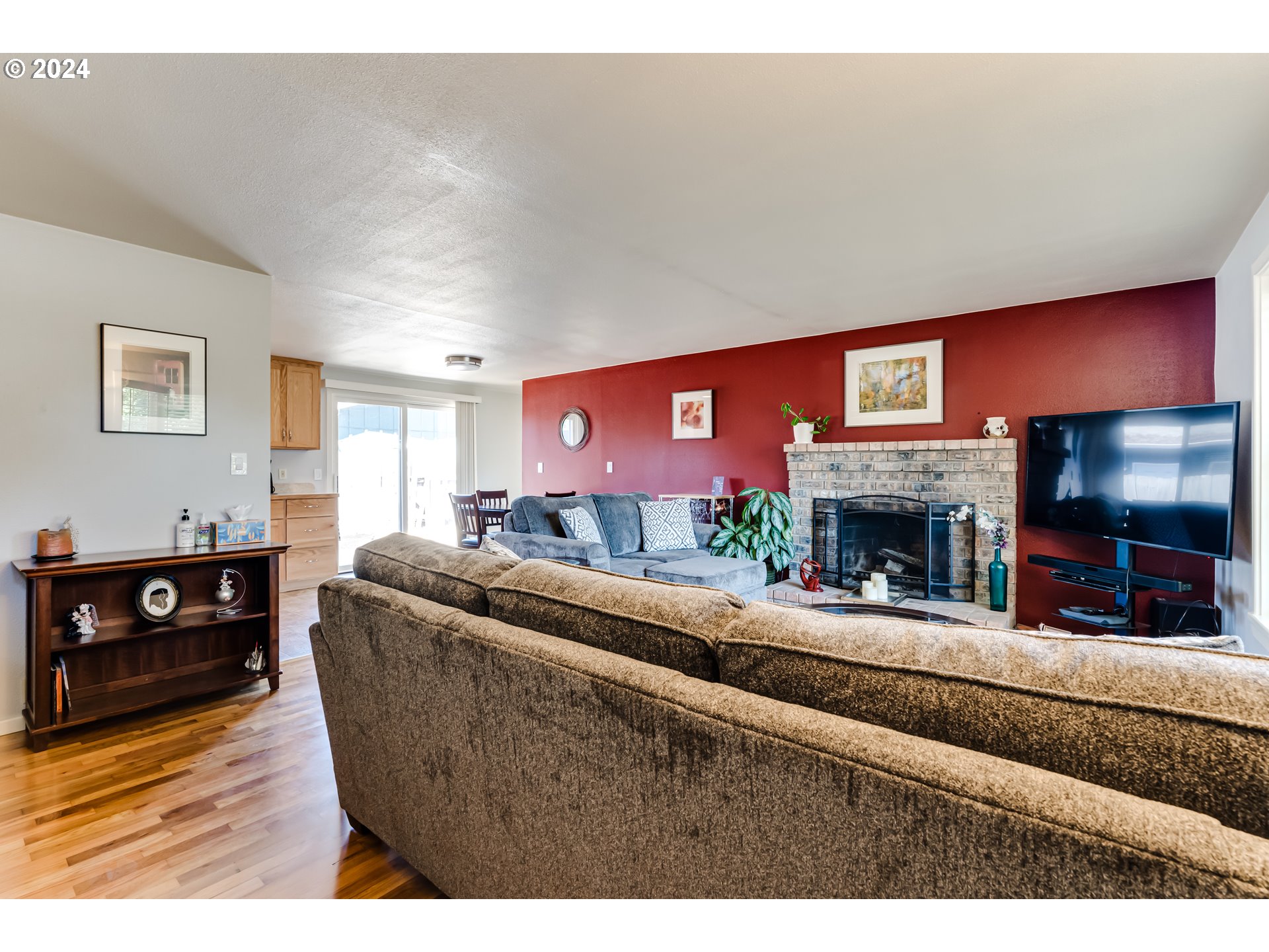3715 Harlow Road Eugene, OR 97401 - Photo 8 of 39 a living room with furniture a flat screen tv and a fireplace