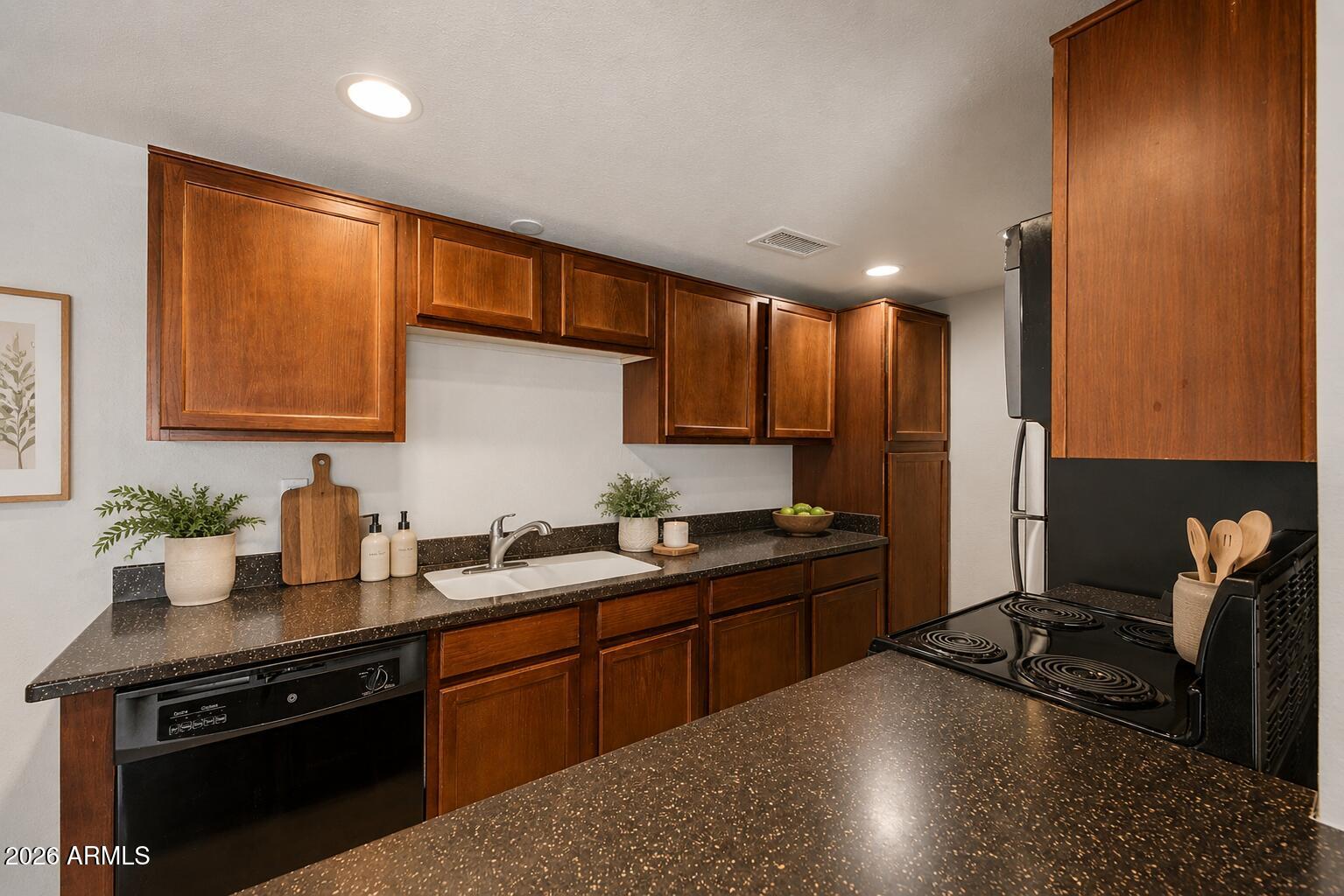 424 West Brown Road, Unit 248 Mesa, AZ 85201 - Photo 6 of 19 a kitchen with a sink stove and cabinets