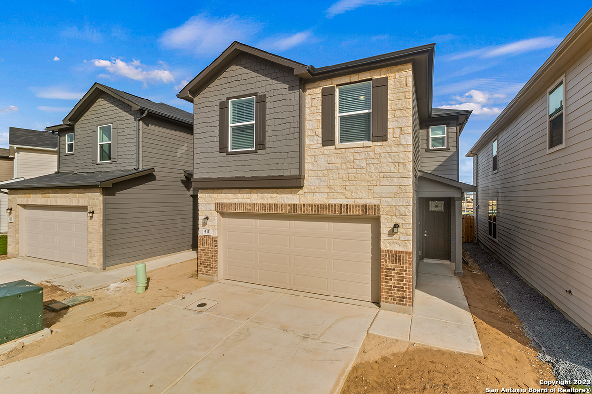 14839 Vance Jackson Road, Unit 411 San Antonio, TX 78249 - Photo 1 of 1 a front view of a house with a garage