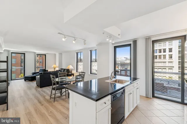 a kitchen with stainless steel appliances granite countertop a sink a stove and a refrigerator