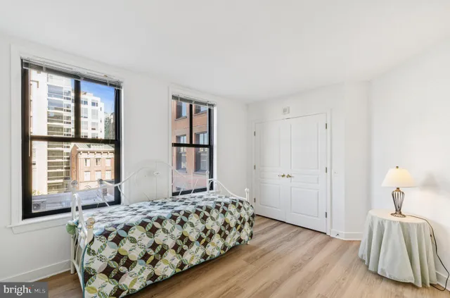a view of a livingroom with wooden floor and a ceiling fan
