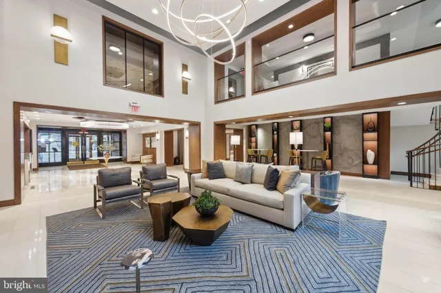 a view of a hallway and a livingroom with furniture