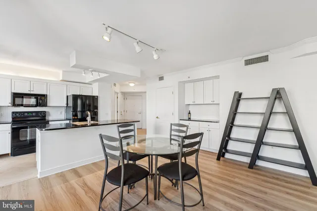 a kitchen with granite countertop a sink counter top space and living room area
