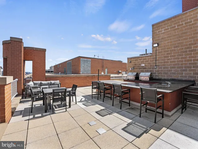 an outdoor space with lots of tables and chairs