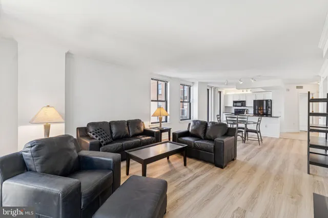 a living room with furniture and a lamp