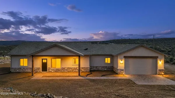 a view of a porch in front of a house with a yard