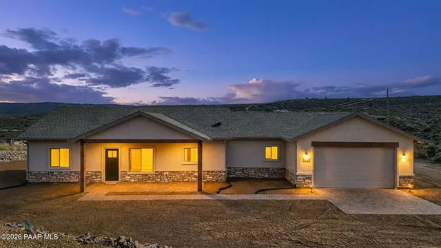 a view of a porch in front of a house with a yard