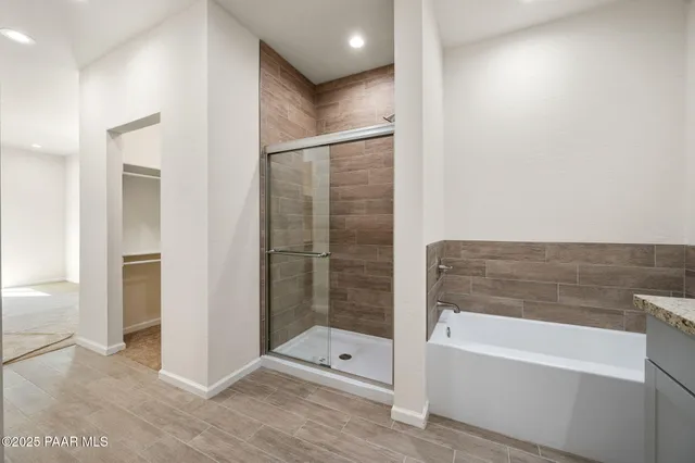 a bathroom with a shower and a bathtub
